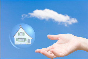 Home in sky with protecting hand